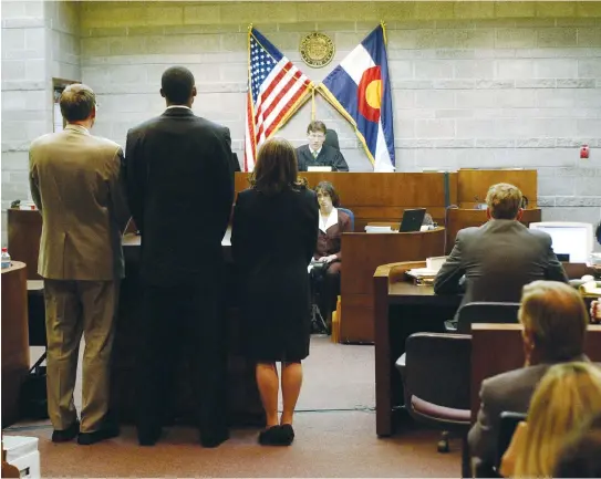  ?? (Reuters) ?? KOBE BRYANT flanked by his attorneys Pamela Mackey and Harold Haddon pleads not guilty at the arraignmen­t in his rape case, with Eagle County District Judge Terry Ruckriegle presiding at the Eagle County Justice Center in Eagle, Colorado, May 11, 2004.