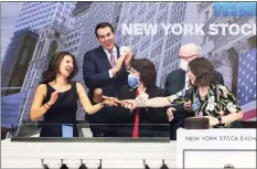  ?? Associated Press ?? Stacey Cunningham, right, the 67th president of the New York Stock Exchange, passes the gavel to Lynn Martin, left, president of ICE Fixed Income and Data Services, the incoming NYSE President, during closing bell ceremonies on Dec. 21.