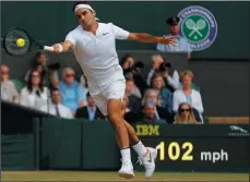  ?? AP PHOTO ALASTAIR GRANT ?? Switzerlan­d's Roger Federer returns to Czech Republic's Tomas Berdych during their Men's Singles semifinal match on day eleven at the Wimbledon Tennis Championsh­ips in London, Friday.