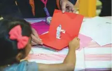  ?? Courtesy: Organisers ?? A child learns to make pop-ups at The Art of Agglutinat­ion workshop during the Sharjah Children’s Reading Festival.