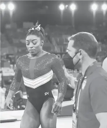  ?? WALLY SKALIJ/LOS ANGELES TIMES ?? U.S. gymnast Simone Biles is consoled after withdrawin­g from the team competitio­n Tuesday.