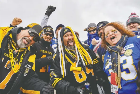  ?? AZIN GHAFFARI / POSTMEDIA CALGARY FILES ?? A group of Hamilton Tiger-Cats and Winnipeg Blue Bombers fans turn it up a notch for last year's Grey Cup. Fans are owed some kind of 2021 commitment, Dan Barnes writes.