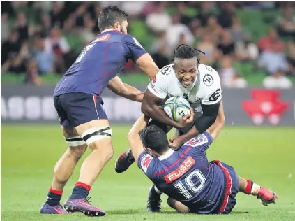  ?? Picture: AFP ?? DOWN TO EARTH. The Rebels’ Jack Debreczeni tackles Sbu Nkosi of the Sharks during their Super Rugby meeting in Melbourne yesterday. The home side won 46-14.