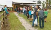  ?? ORLANDO SENTINEL RICARDO RAMIREZ BUXEDA/ ?? Customers line up to order from the Blueberry Grill during the third annual Homeschool U-Pick day at Double C Bar Ranch Blueberry Farm in Kenansvill­e.