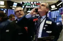  ?? RICHARD DREW — THE ASSOCIATED PRESS ?? Traders Eric Schumacher, left, and Richard Deviccaro work on the floor of the New York Stock Exchange, Thursday, Nov. 8.