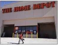  ?? (AP) ?? A Home Depot employee walks outside a company store in Niles, Ill., in February.