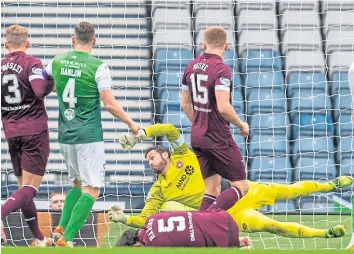  ?? ?? Craig Gordon dives full length to thwart yet another Hibs attempt on goal