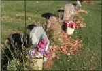  ?? BILL DEBUS - THE NEWS-HERALD ?? Flowers appear near several headstones at Perry Cemetery in Perry Township on Nov. 3.