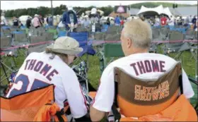  ?? HANS PENNINK — ASSOCIATED PRESS ?? Jim Thome fans Betsy Yolchim, left, and her husband Tomm Betsy, of Erie, Pa., wait for the start of Baseball Hall of Fame induction ceremonies July 29 in Cooperstow­n, N.Y.