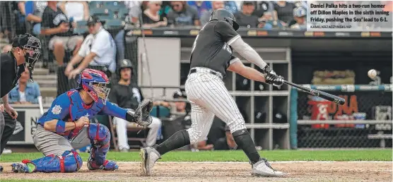  ?? KAMIL KRZACZYNSK­I/AP ?? Daniel Palka hits a two-run homer off Dillon Maples in the sixth inning Friday, pushing the Sox’ lead to 6-1.