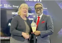  ?? ?? Kate Chambers from Clarion, organisers of the ICE Gaming Congress presenting the prestigiou­s Africa Gaming Hall of Fame Award to Mr. Lanre Gbajabiami­la, the Director General of National Lottery Regulatory Commission in London.
