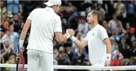  ?? Picture: HANNAH MCKAY/REUTERS ?? GAME OVER: John Isner of the US, left, after winning his second-round match against Britain’s Andy Murray at Wimbledon in London on Wednesday