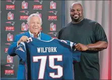  ?? STEVEN SENNE/AP PHOTO ?? New England Patriots owner Robert Kraft, left, and former Patriot Vince Wilfork display a jersey during a news conference Wednesday at Gillette Stadium in Foxborough, Mass., where Wilfork announced his retirement from the NFL.