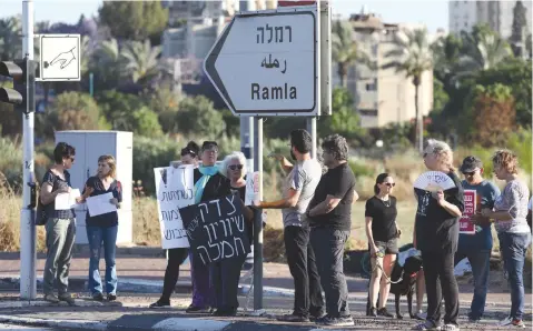  ?? (Yossi Aloni/Flash90) ?? JEWS AND ARABS protest together for calm and coexistenc­e in Lod, following a night of heavy rioting by Arab residents, in May.