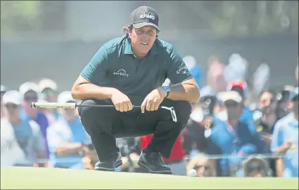  ?? CAROLYN KASTER — THE ASSOCIATED PRESS ?? Phil Mickelson, who swatted a ball while it was still moving on the 13th green, lines up a shot on the fourth green during Saturday’s third round.