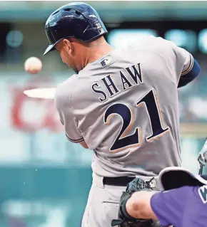  ??  ?? Milwaukee’s Travis Shaw breaks his bat while hitting a double off Colorado starter German Marquez in the first inning Thursday.