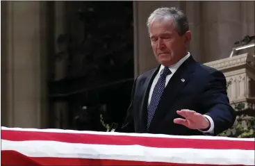  ?? ALEX BRANDON — GETTY IMAGES ?? Former President George W. Bush touches the casket of his father after delivering an emotional eulogy Wednesday.