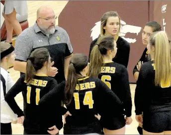  ?? MARK HUMPHREY ENTERPRISE-LEADER ?? Lady Tigers Huddle. Prairie Grove coach Mat Stewart takes time-out to get the Lady Tiger volleyball team reorganize­d during a match at Lincoln. The Lady Tigers competed in the district tournament this week at Lincoln.