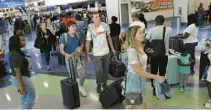  ?? CARLINE JEAN/SOUTH FLORIDA SUN SENTINEL ?? Do airports stress you out? Travelers on Jan. 2 faced delays of up to eight hours at Fort Lauderdale-Hollywood Internatio­nal Airport due to issues with air traffic computers.