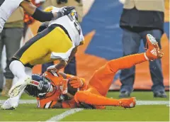  ??  ?? Broncos wide receiver Emmanuel Sanders pulls in a first down and goal catch as Steelers cornerback Joe Haden defends during the first half.