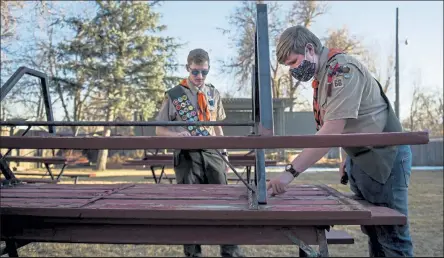  ?? Timothy Hurst
/
Staff Photograph­er ?? Longmont Boy Scout Troop 66 Scouts Kyle Taylor, right, and Jackson Staats look over a set of picnic tables on Wednesday that Staats refurbishe­d as part of his Eagle Scout project at Old Mill Park in Longmont.