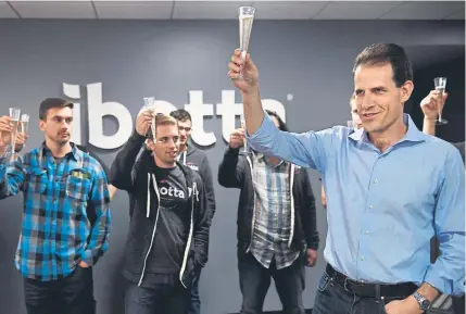  ?? Joe Amon, Denver Post file ?? Ibotta founder and CEO Bryan Leach, right, celebrates an overhaul of the mobile shopping app with his team in 2017. This week, Ibotta became Denver’s only billion-dollar startup. Ibotta made its debut in 2012.