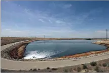  ?? CALIFORNIA­N FILE PHOTO ?? Water from a Chevron polishing pond flows into the Cawelo Water District’s reservoir B northwest of Bakersfiel­d in 2015.
