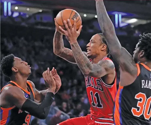  ?? SETH WENIG/AP ?? Bulls star DeMar DeRozan (11) says Knicks guard Quentin Grimes’ ‘‘jittery’’ feet gave him all the opening he required to make the winning shot Friday.