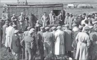  ??  ?? A sale at Milton in South Uist in the 1950s, with George McCallum auctioneer­ing.