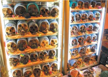  ?? PHOTO BY CAITLIN DOUGHTY FOR THE WASHINGTON POST ?? A wall of special skulls, called Natitas, in La Paz, Bolivia, aid their devotees in love, protection and finances.