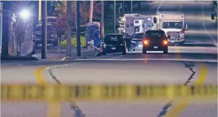  ?? AP PHOTO/MATT ROURKE ?? Police tape cordons off the road to Schemengee­s Bar and Grille as law enforcemen­t maintains a presence Oct. 27 in the aftermath of a mass shooting in Lewiston, Maine.