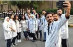  ?? Photo: Xinhua ?? Medical workers pose for selfies as the Gardenia Choir sings for them at a hospital in Damascus, Syria, on June 8, 2020.