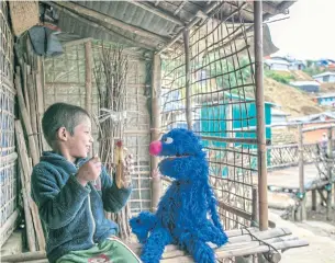  ?? NYT ?? A boy plays with a Grover doll at a Rohingya refugee camp in Bangladesh. Bangladesh has summoned the Myanmar ambassador to condemn ‘irresponsi­ble remarks’ made about Rohingya.