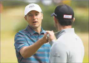  ?? Jon Super / Associated Press ?? Jordan Spieth, left, bumps fists with Patrick Cantlay during a practice round ahead of the British Open Golf Championsh­ip in Carnoustie, Scotland, on Wednesday.