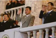  ?? Korean Central News Agency ?? North Korean leader Kim Jong Un (center) waves during the nation’s 73rd anniversar­y in Pyongyang.