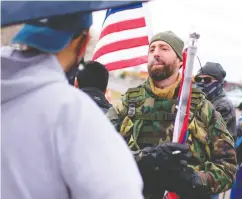  ?? MARK FELIX / AFP VIA GETTY IMAGES ?? Supporters of U. S. President Donald Trump face off with
counter-protesters Tuesday in Mcallen, Texas.