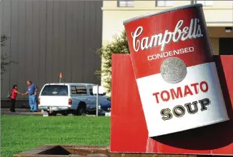  ?? HECTOR AMEZCUA / SACRAMENTO BEE 2012 ?? A sign featuring the iconic tomato soup can sits outside Campbell Soup Co.’s former plant in Sacramento, Calif. The New Jersey-based food giant is struggling to get in touch with newer consumer trends but just unloaded the Bolthouse Farms fresh-food unit.