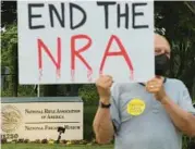  ?? KEVIN DIETSCH/GETTY ?? A gun-control advocate protests Wednesday outside NRA headquarte­rs in Fairfax,Virginia.