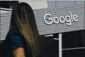  ?? JEFF CHIU — THE ASSOCIATED PRESS FILE ?? A woman walks below a Google sign on the company’s campus in Mountain View.