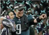  ?? FRANK FRANKLIN II - AP ?? Eagles quarterbac­k Nick Foles (9) holds his daughter, Lily James, after winning the Super Bowl 52 against the New England Patriots, Sunday, in Minneapoli­s. The Eagles won 41-33.