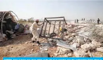  ?? — AFP ?? BARISHA, Syria: A Syrian man clears debris at the site of an operation near this northweste­rn Syrian village in Idlib province yesterday.