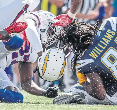  ?? ROBERT GAUTHIER TRIBUNE NEWS SERVICE ?? Bills cornerback Tre’Davious White separates Chargers receiver Mike Williams from his helmet but not the ball in Sunday’s game. Williams had a touchdown in the win on a wild day in the NFL.