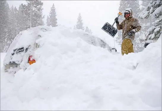  ?? PHOTOS BY JANE TYSKA — STAFF PHOTOGRAPH­ER ?? Jake Coleman digs out his car along North Lake Boulevard as snow continues to fall in Tahoe City on Saturday, although he says he had nowhere to go.