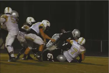  ??  ?? Rockmart quarterbac­k Griffin Earwood takes a sack during the first half against Cedartown.