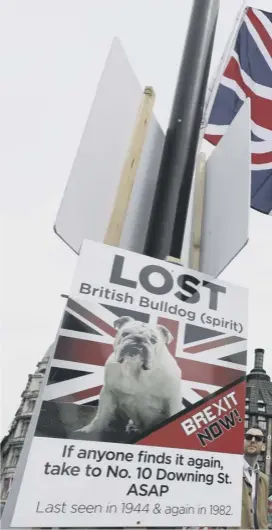  ??  ?? A pro-brexit poster is displayed outside Westminste­r on the eve of the European elections as Theresa May fought off another coup attempt by the Tory party