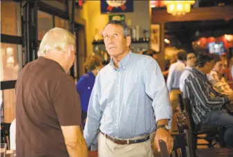  ?? Hunter McRae / New York Times ?? Rep. Mark Sanford, R-S.C., with backers in Mount Pleasant, lost his primary race to state Rep. Katie Arrington after President Trump lashed out at him just hours before the polls closed.