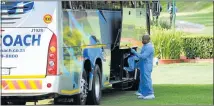  ?? Picture: AFP PHOTO/PHILL MAGAKOE ?? SEARCHING FOR CLUES: Police forensic investigat­ors look for fingerprin­ts on the tour coach