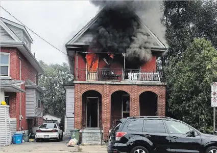  ?? URSULA PRINCE SUBMITTED ?? Flames and smoke pour out of a house at 703 Wilson St. early Thursday morning.