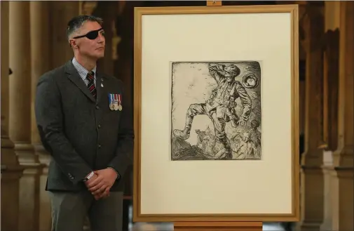  ?? Pictures: Colin Mearns ?? „ Lance Corporal David Timmins with a lithograph­ic print by Frank Brangwyn and featuring in the exhibition at the Kelvingrov­e Art Gallery.