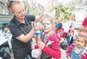  ??  ?? Six-year-old Lara Fernandez gets her face painted.